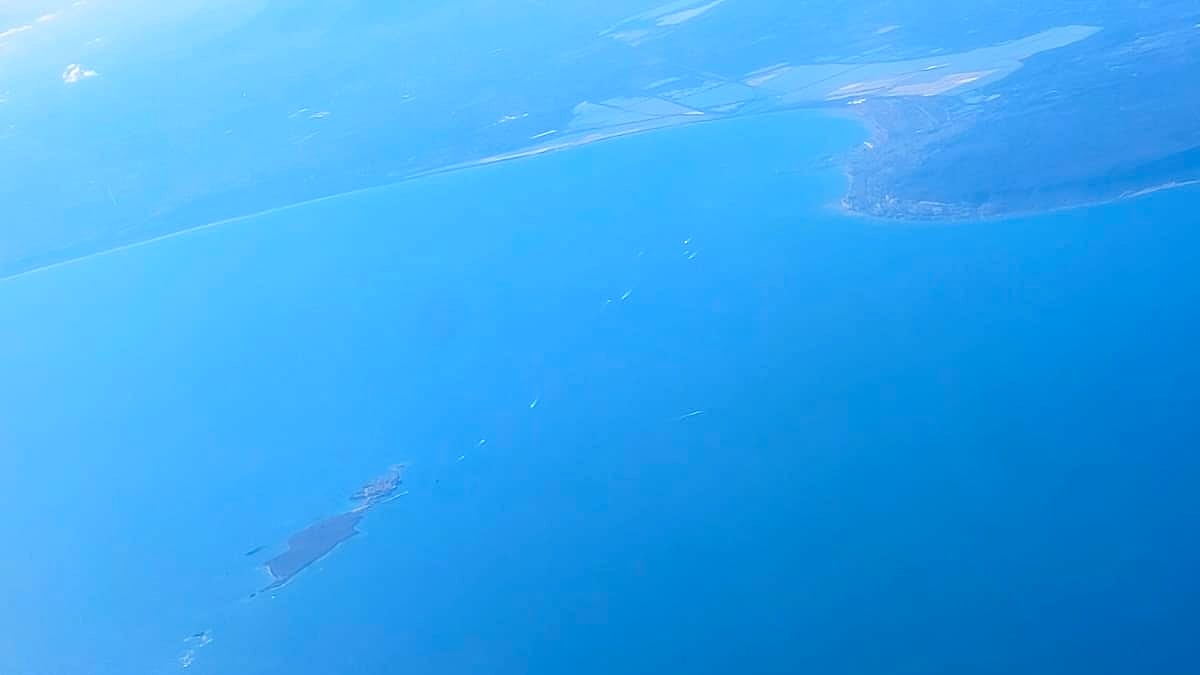 Aerial view of the bay of Santa Pola, the salt flats and Tabarca island, seen from a plane
